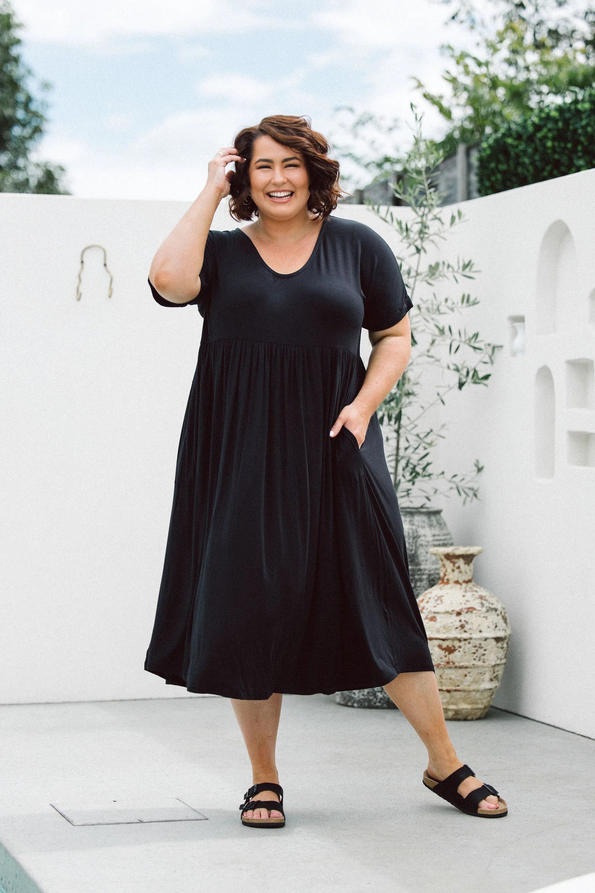 Model displaying women's plus size dress online - Ashleigh Dress in Black by Peach The Label